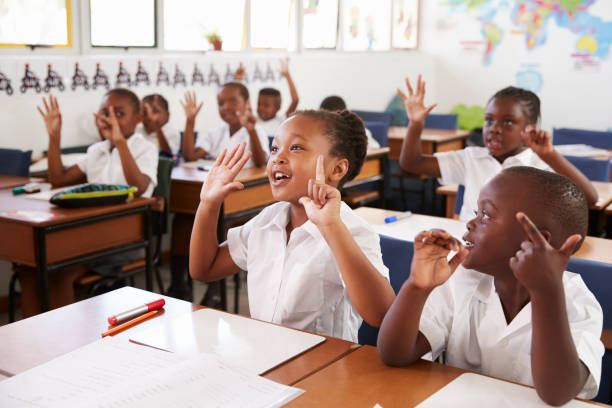 Emuna classroom with learners eagerly raising their hands