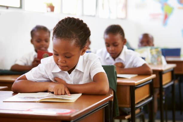 Young Emuna learner reading independently at her desk